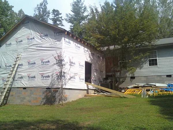 Tyvek wrapped gable on a new room addition beside an existing home in Shiloh